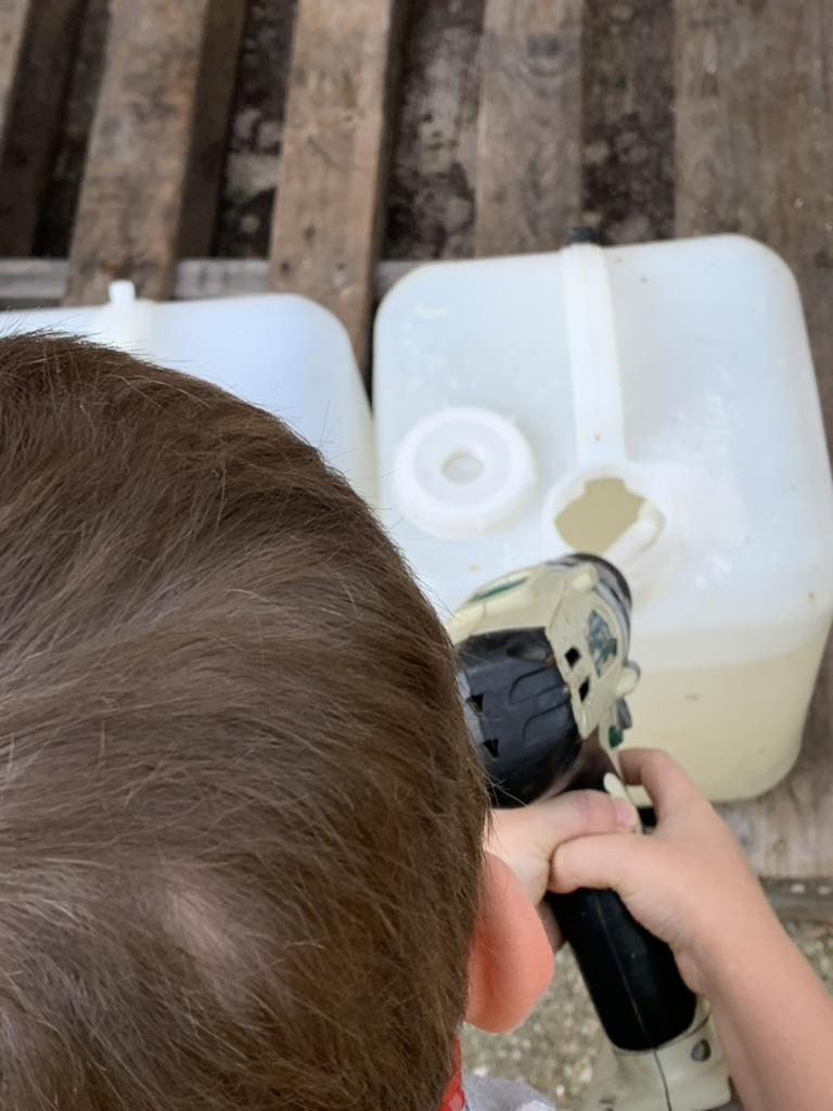 Child using a power tool to mix syrup in a jug